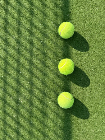 tennis ball on tennis grass courtの写真素材