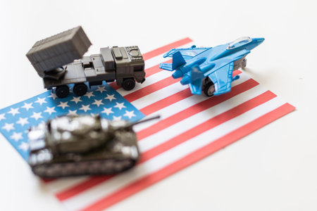 Miniature toy soldiers in battle scene with american flag background , Memorial Day conceptの写真素材