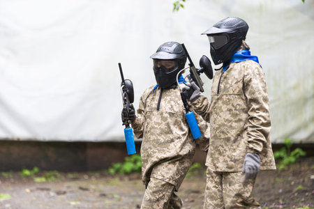 children playing paintball in the forestの写真素材