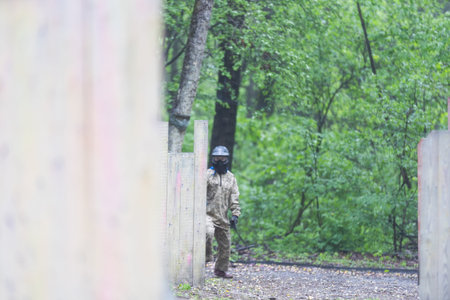 children playing paintball in the forestの写真素材