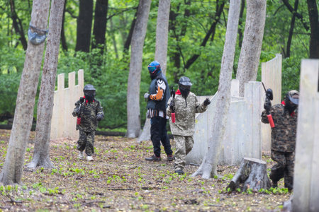 children playing paintball in the forestの写真素材