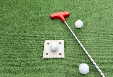 Mini golf close-up, colorful golf putters, balls