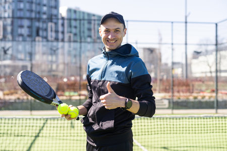 paddle player resting against the wall entertained by the ballの写真素材