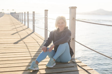 A sexy woman on floating pontoon towards a posh resort. Lifestyle and recreation.の写真素材