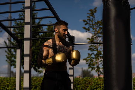 young naked boxer wearing protecting gloves.の写真素材
