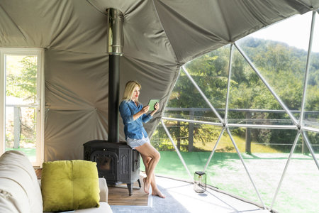 woman with tablet in dome tent
