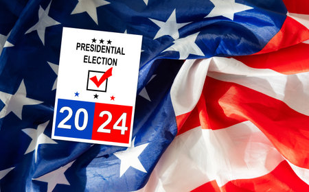 Politics and voting concept. Presidential election 2024 text on white paper over the American flag backgroundの写真素材