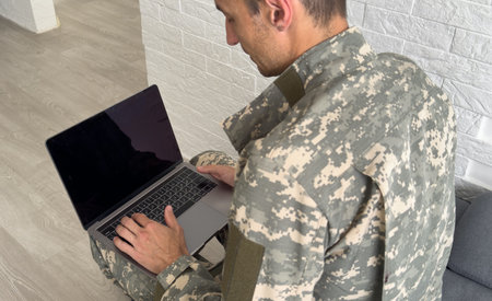 Soldier with laptop on white backgroundの写真素材