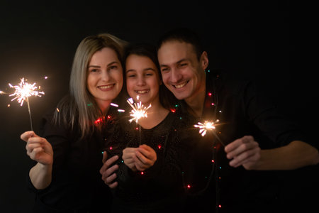 family with garland on a black backgroundの写真素材