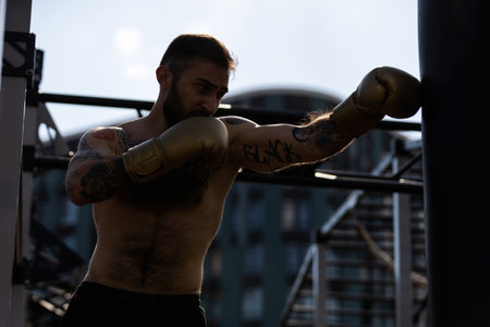 a man trains in boxing gloves on the streetの写真素材