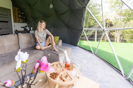 woman tourist in transparent dome hotel glampingの写真素材