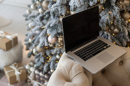 Christmas decorated working space with a laptop on the desk, social media holiday concept with blank space for a textの写真素材