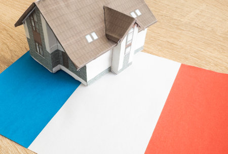 House model near France flag. Real estate sale and purchase concept. Space for text.の写真素材