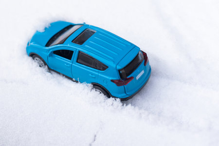 toy car riding by snow backgroundの写真素材