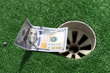 Mini Golf club, money on the artificial grassの写真素材