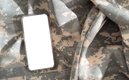 Blank mobile phone on military equipment, template for SMS, Ukrainian Armed Forcesの写真素材