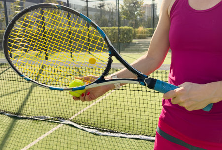 Woman with tennis racquet and ballの写真素材