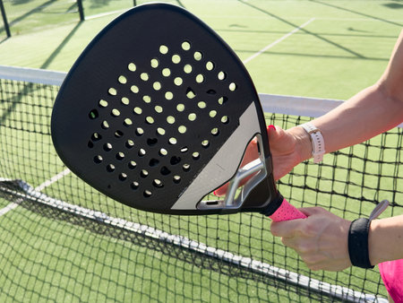 A girl with a paddle racket on an outdoor court. Concept of women playing paddle. Paddle sport. Ukraine Kyiv, April 02 2024の写真素材