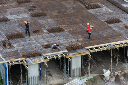 workers make reinforcement for concrete foundationの写真素材