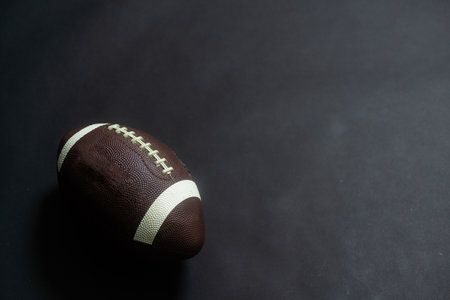 American football ball isolated on black backgroundの写真素材