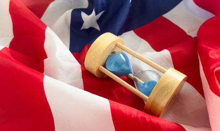 USA red white and blue flag with hour glass showing time is running out for democracy freedom and the American wayの写真素材