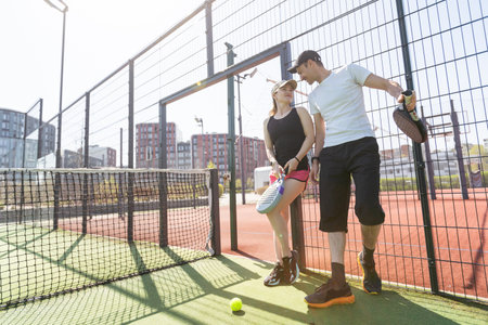 paddle tennis couple players ready for classの写真素材