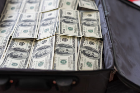 100 dollar bills in a suitcaseの写真素材