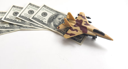 Background of one hundred dollar bills with model fighter airplaneの写真素材