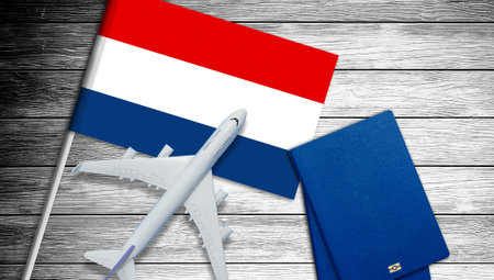 Illustration of a passenger plane flying over the flag of the Netherlands. Concept of tourism and travelの写真素材