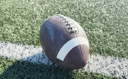 American Football on the Field Close Up with Yard Lines Beyondの写真素材