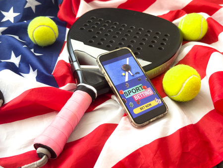USA flag, padel racket and smartphone with sports bettingの写真素材