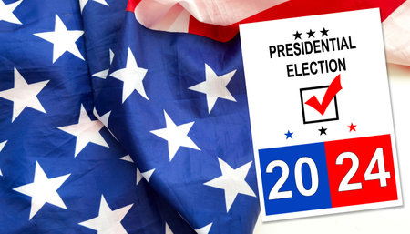 Politics and voting concept. Presidential election 2024 text on white paper over the American flag backgroundの写真素材