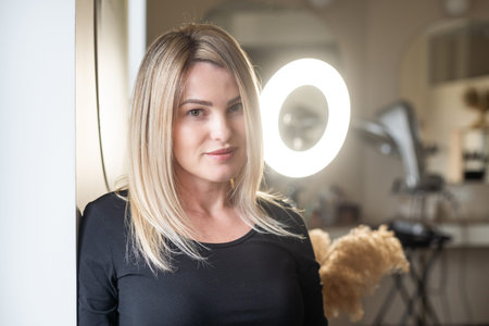 blonde woman in mirror with perfect skin.の写真素材