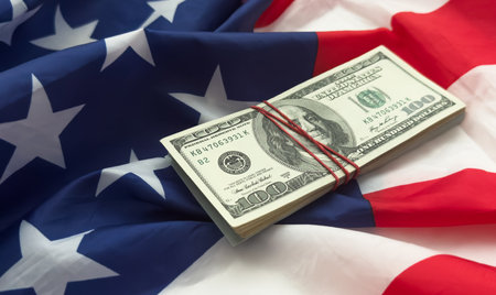 One hundred dollars banknotes on flag backgroundの写真素材