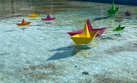 colored paper boat on a lake in the waves