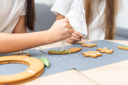 Kids decorating cookies in the kitchen.の写真素材