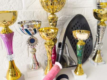 Gold cup with sports equipment padel racketの写真素材