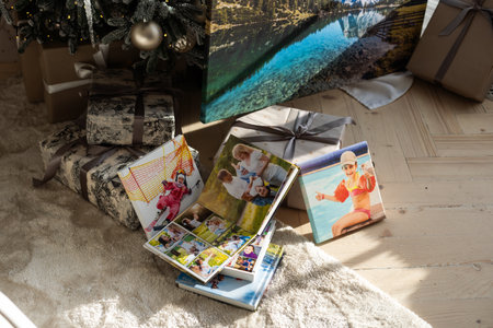 Photo printing, Christmas family memories. Small boy looking at Christmas printed photos.の写真素材