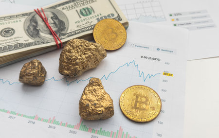Economic concept: Crypto currency, money and gold on global stock markets. Three shiny bitcoin and two gold pieces lying on some EURO and US dollar banknotes. Black background with copy spaceの写真素材