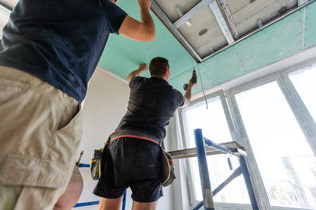 The construction workers doing the installation work for new construction area.の写真素材
