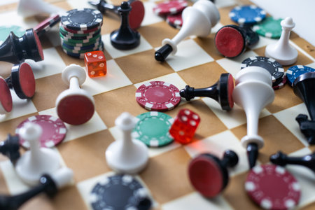 Wooden checkers, chess pieces, playing cards, board games on a light table close up.の写真素材