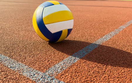 A volley ball is placed on a floorの写真素材