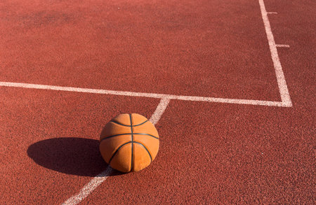 basketball ball on the outdoors court with hoop on the background. Sport equipmentの写真素材