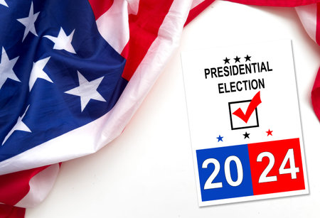 Politics and voting concept. Presidential election 2024 text on white paper over the American flag...