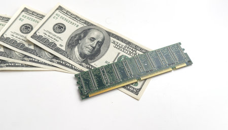 Computer CPU and memory chips on US dollar banknotes background. The high cost of microelectronics conceptの写真素材