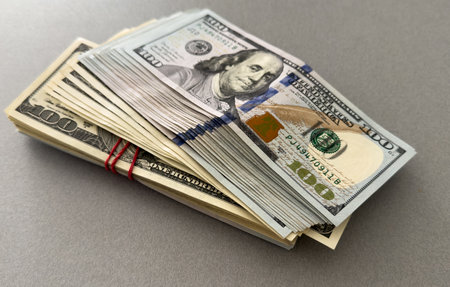 Stack of hundred dollars isolated on whiteの写真素材