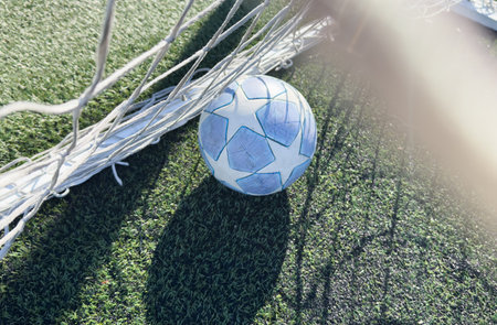 soccer ball flies into the gate on a green background. Close up.の写真素材