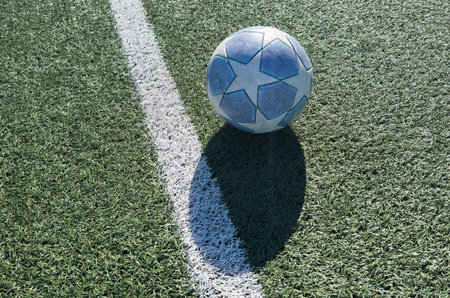 a soccer ball on the green grass in soccer stadium.