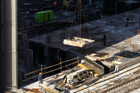 Tower crane on formwork at construction site. Truck mounted concrete pump. Reinforced concreting....