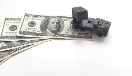 a model of a military car on dollars